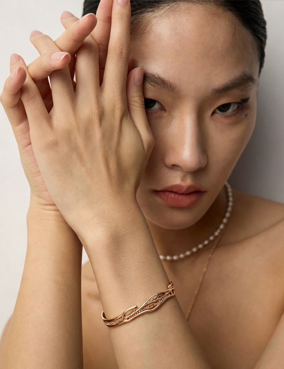 Élan crystal cuff bracelet in vintage gold worn on wrist