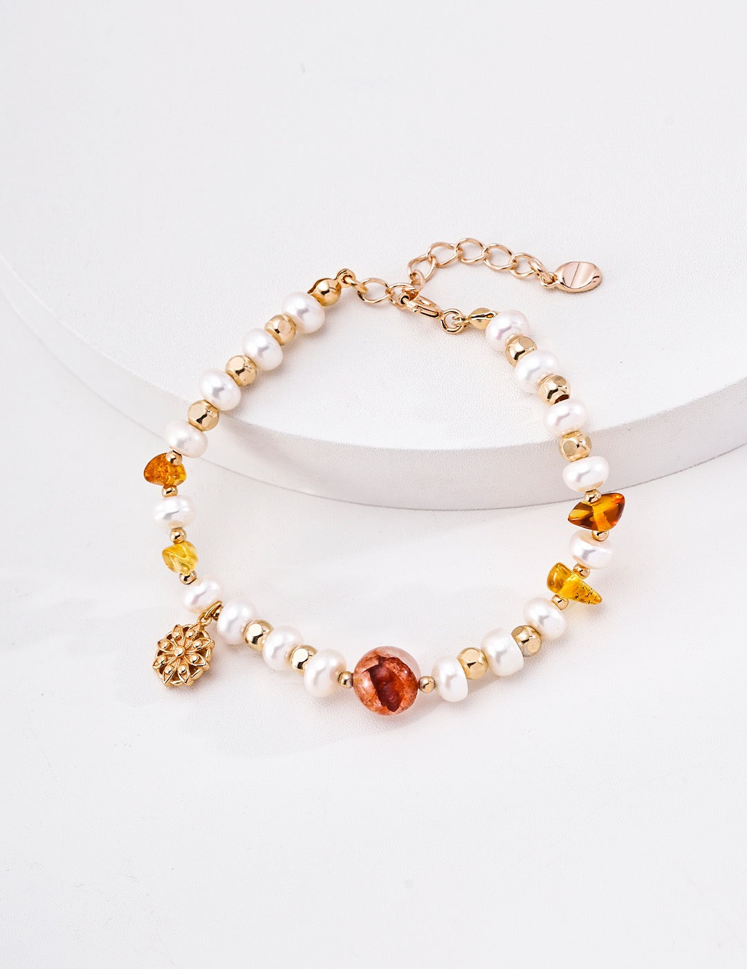 Solène pearl and crystal bracelet in vintage-gold finish on a white display