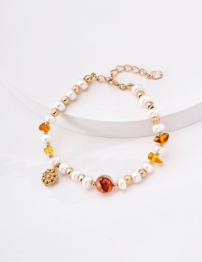 Solène pearl and crystal bracelet in vintage-gold finish on a white display