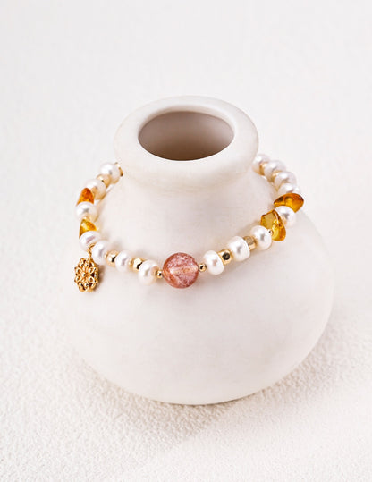 Solène pearl and crystal bracelet displayed around a ceramic vase