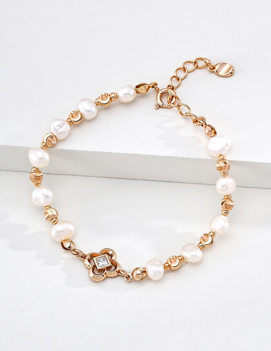 Petite Fleur bracelet styled with layered pearl bracelets