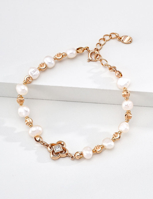 Petite Fleur bracelet styled with layered pearl bracelets