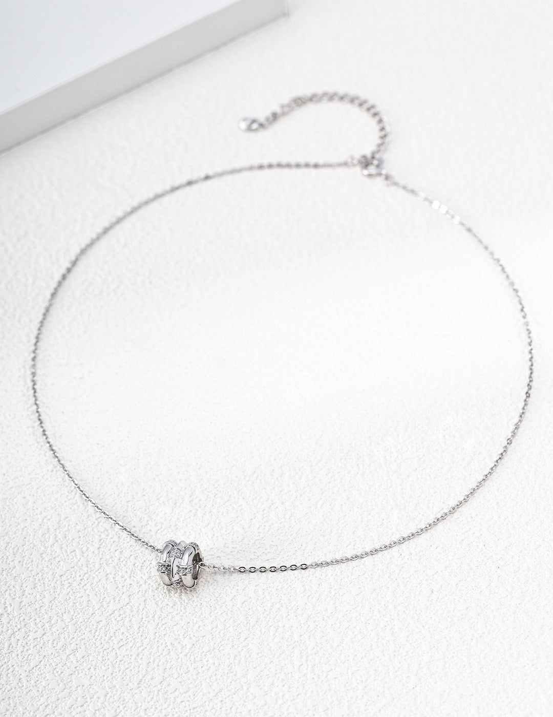 Gold and silver Astra wheel pendant necklaces with cubic zirconia