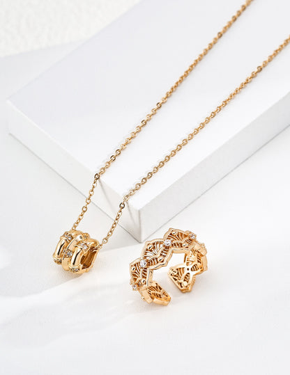 Astra gold pendant necklace beside matching sculptural jewelry