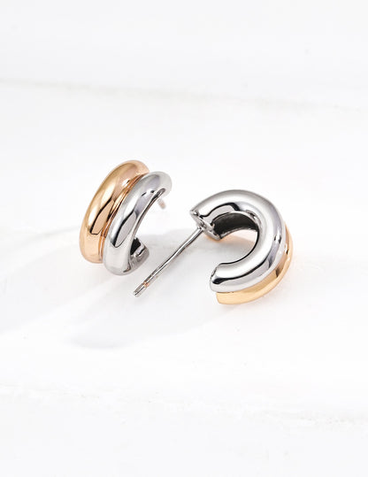 Gold Trinité huggie earrings styled with a pendant necklace