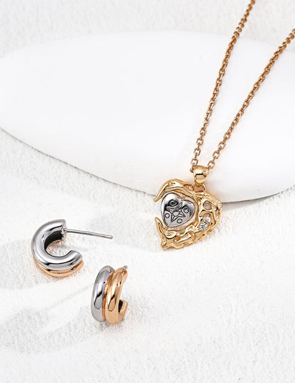Trinité huggie earrings in gold, silver, and two-tone finishes