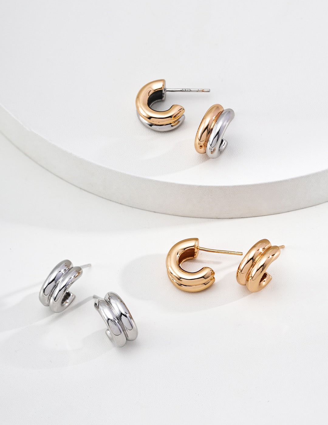 Silver and two-tone Trinité huggie earrings with sculptural bands